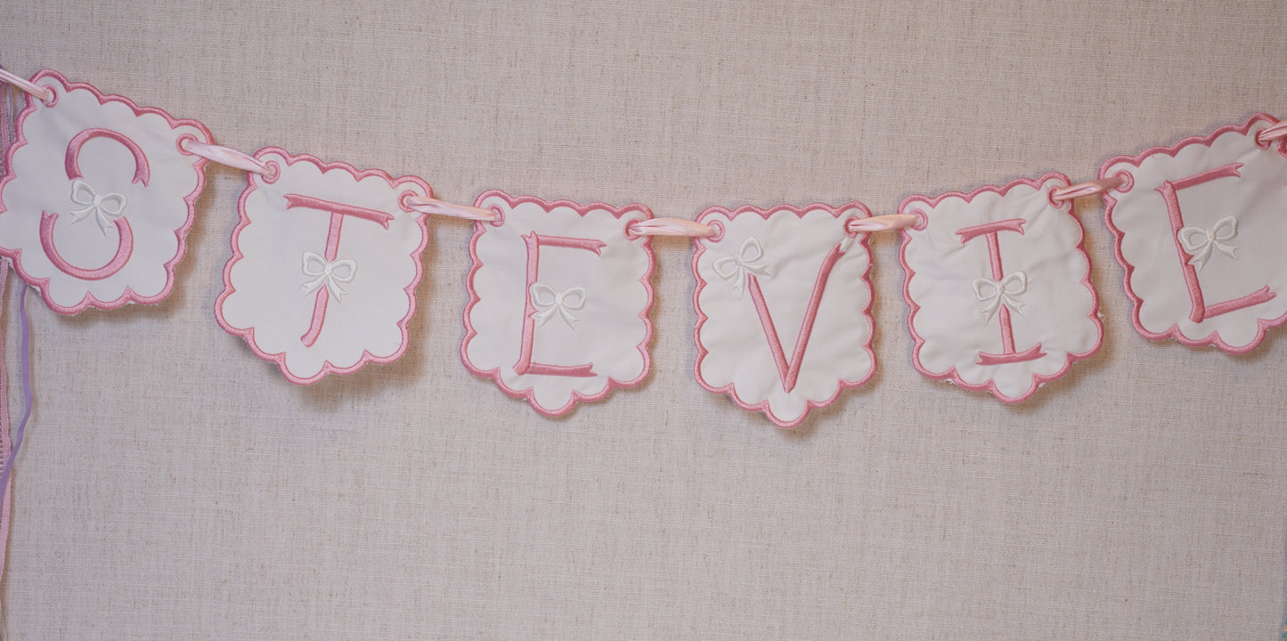 Embroidered baby banner for nursery; pink and white