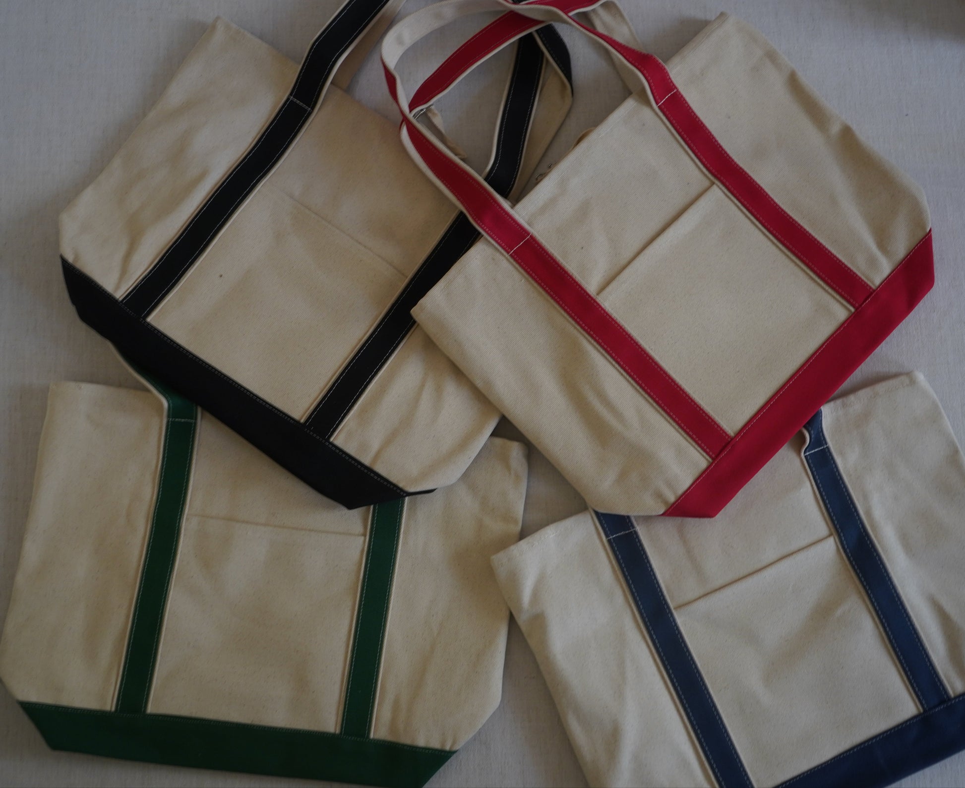 different color tote bags to choose from. Green, Red, Navy, Black